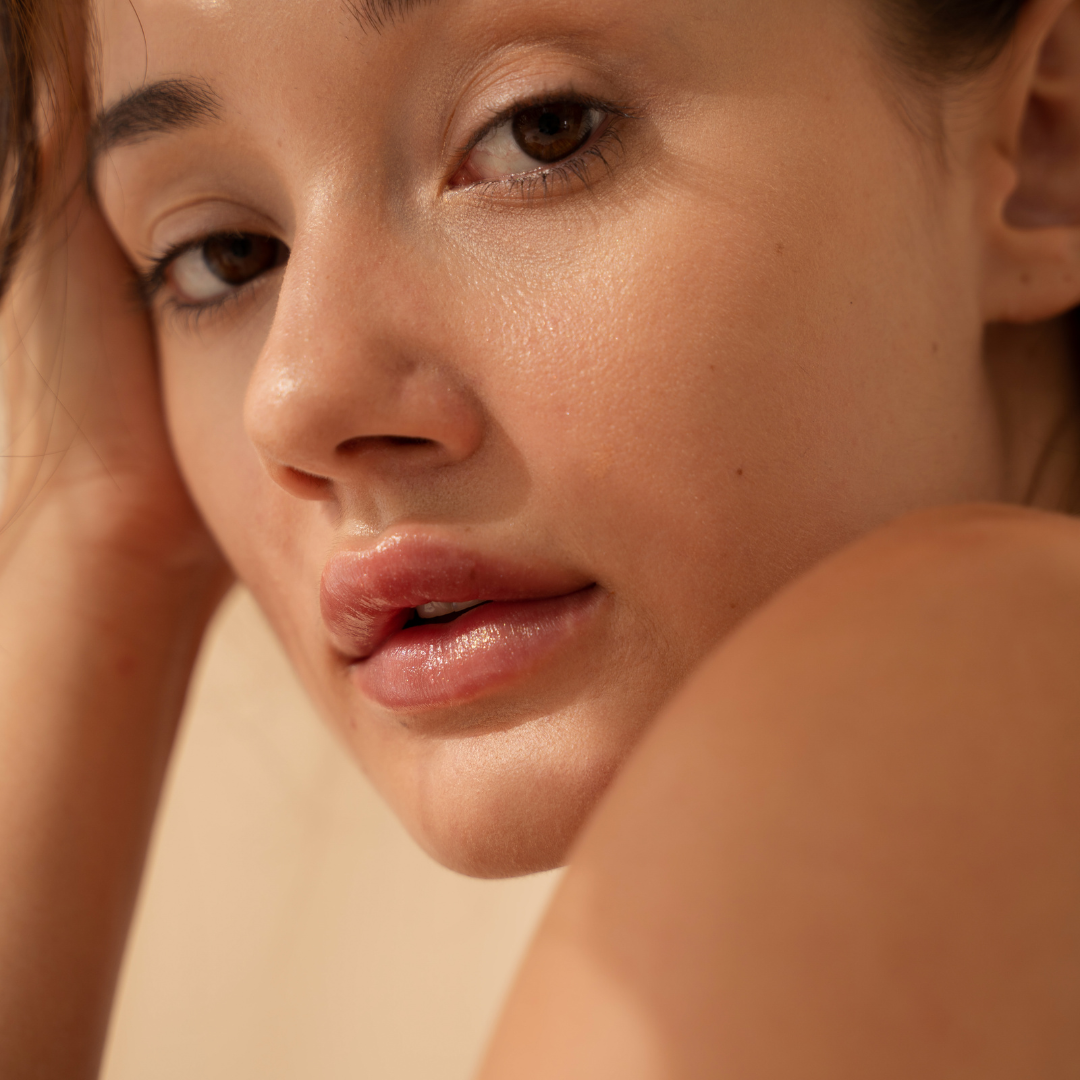 Woman with smooth, radiant skin looking over her shoulder