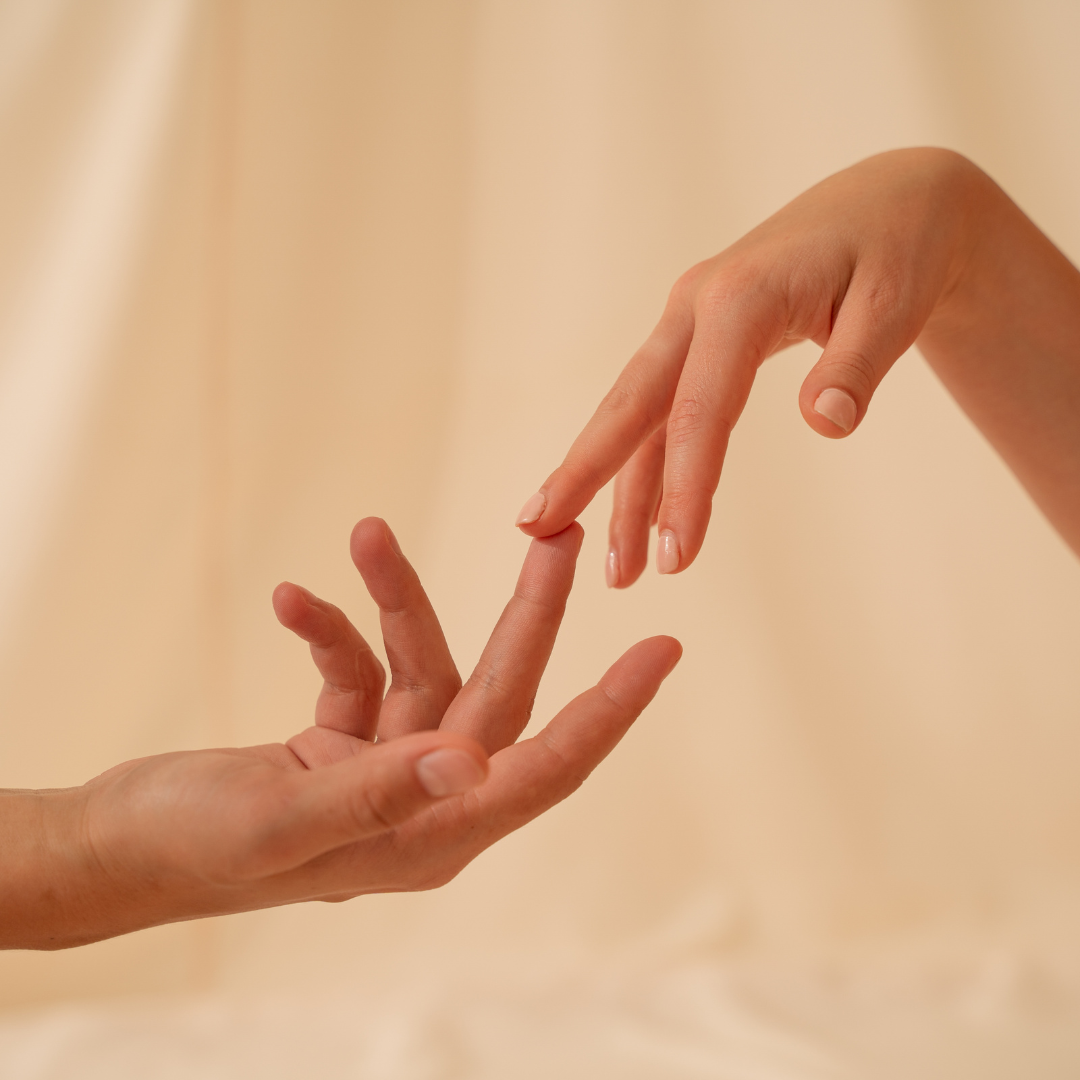 Two hands reaching towards each other