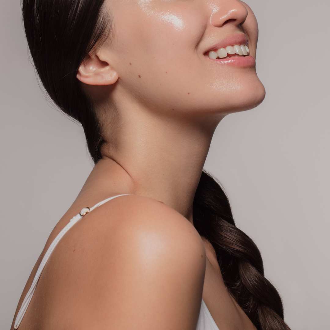 Smiling woman with glowing, hydrated skin